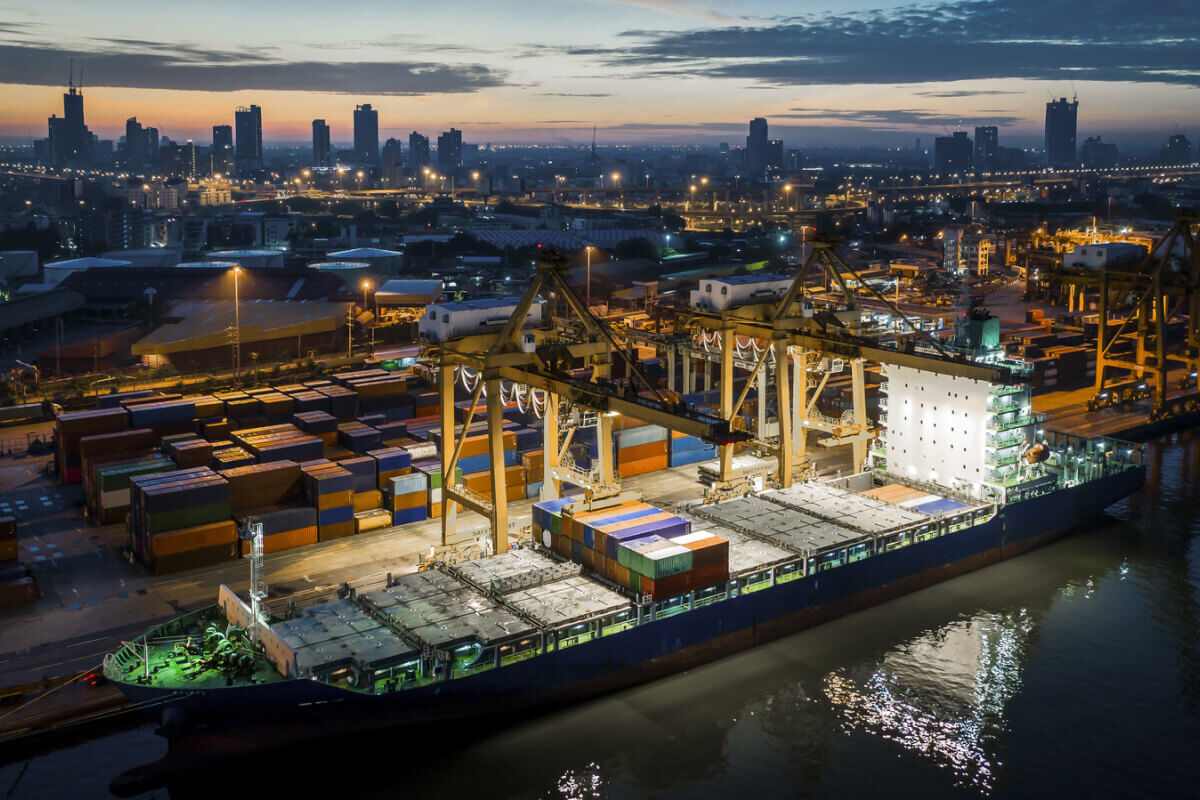 Ship in dockyard with city in background